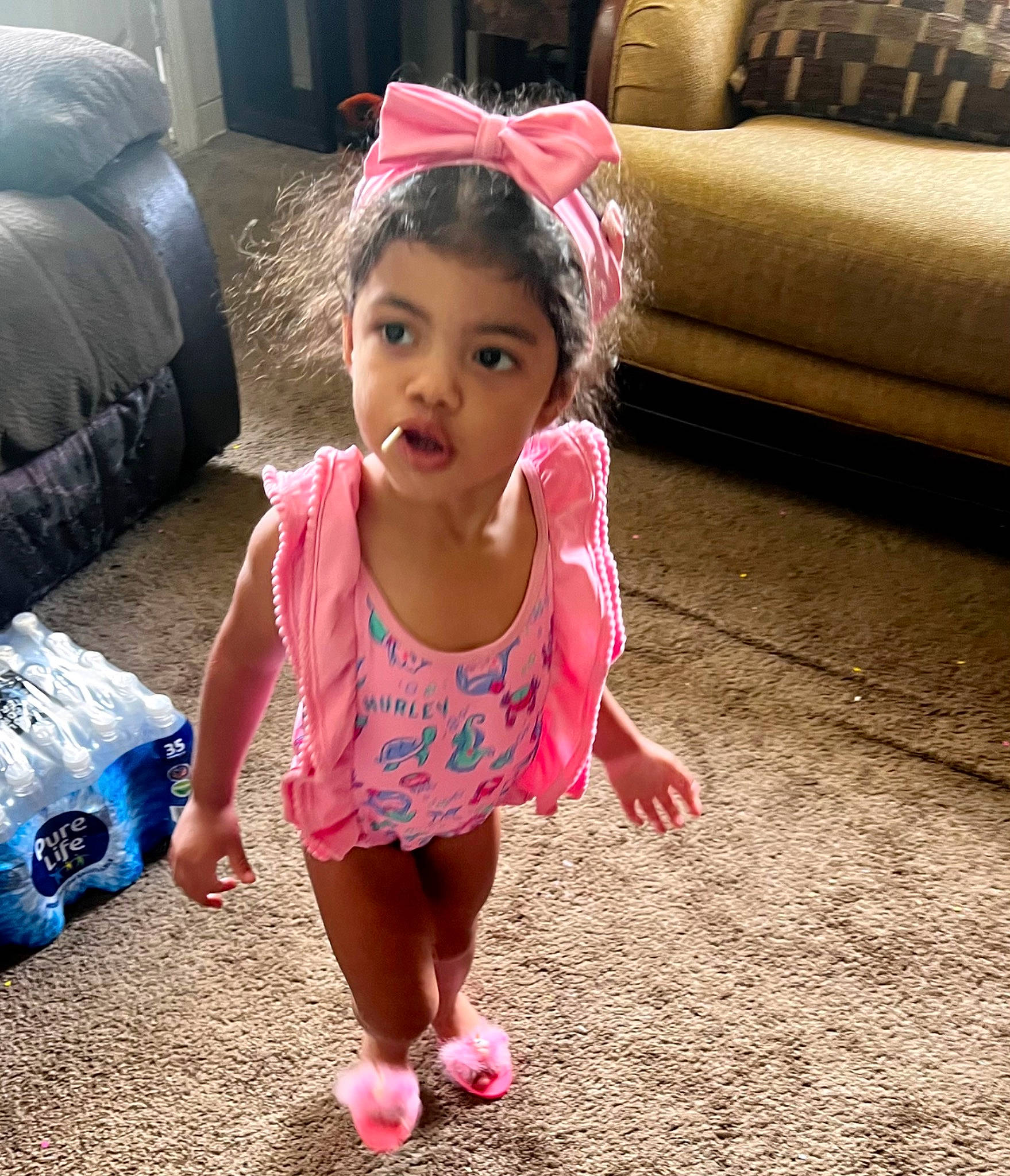 Kitana joined the competition — help win amazing prizes! baby_toddler_clothing, barefoot, black_hair, child, comfort, couch, foot, fun, happy, head, human_leg, leisure, living_room, magenta, morning, person, pink, play, sitting, t_shirt