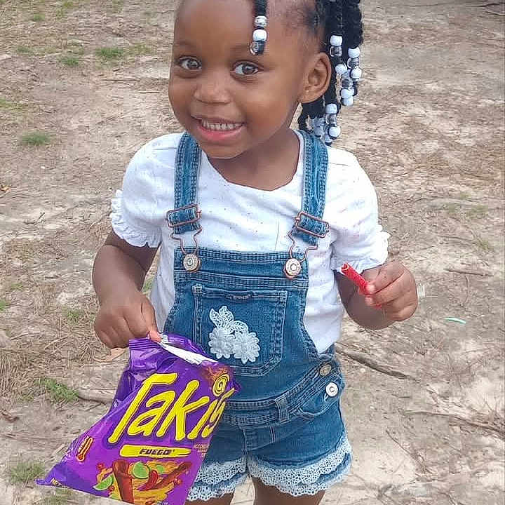 Ka'Lee is registered to the contest to win money with this photo: architecture, child, city, clothing, face, female, girl, head, machine, pants, person, photography, plant, portrait, pottedplant, road, shorts, street, urban, wheel