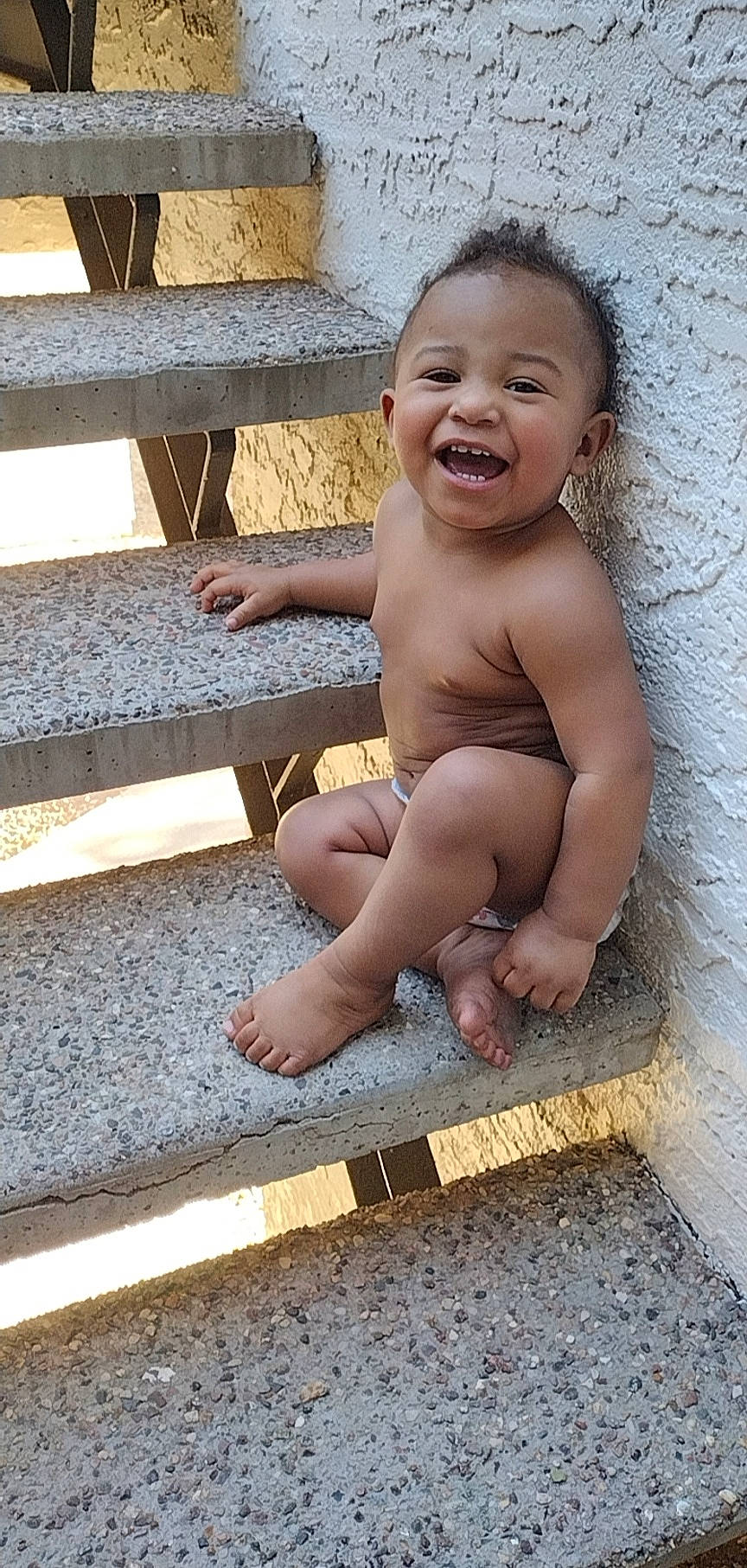 Izaiah joined the competition — help win amazing prizes! baby, baby_toddler_clothing, barechested, barefoot, cheek, chest, child, face, finger, flash_photography, floor, flooring, foot, happy, human_leg, person, sitting, skin, smile, toddler