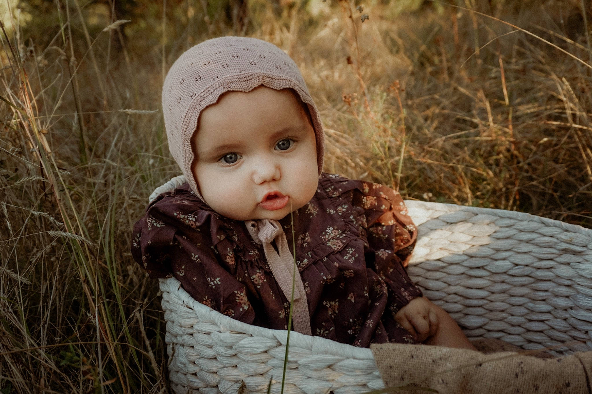 Lottie is registered to the contest to win money with this photo: baby, baby_toddler_clothing, beauty, cap, child, face, flash_photography, fur, grass, grassland, happy, headwear, knit_cap, pattern, people_in_nature, person, plant, sitting, toddler, winter