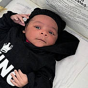 Genesis joined the competition — help win amazing prizes! baby, infant, child, hoodie, black_clothing, lying_down, hand, face, eyes, expression, bed, blanket, warning_label, text, indoor, soft_lighting, cute, person, portrait, closeup