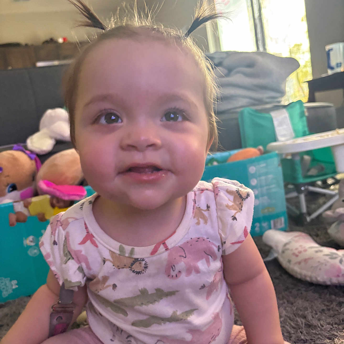 Maddie joined the competition — help win amazing prizes! baby, carpet, child, cute, face, furniture, happy, home, indoors, natural_light, person, pigtails, pink_pants, playtime, shirt, sitting, smiling, toddler, toys, window