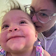 Maddie joined the competition — help win amazing prizes! baby, child, adult, glasses, hoodie, smile, face, indoor, closeup, hair, affection, person, portrait, colorful_clothing, happy, family, candid, warm, skin, background