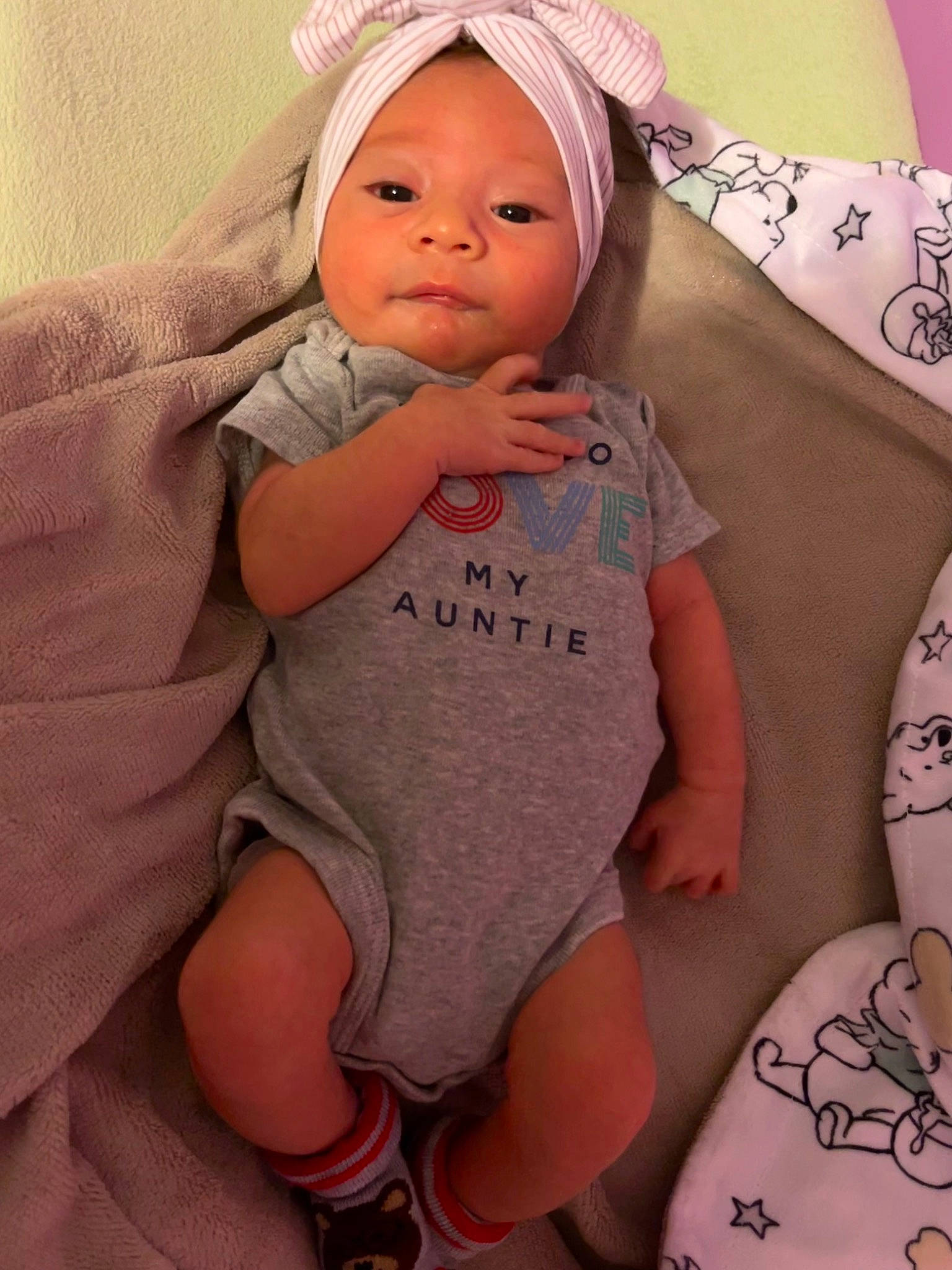 Nairobi is registered to the contest to win money with this photo: arm, baby, baby_toddler_clothing, cap, cheek, chin, comfort, face, finger, hand, headwear, linens, lip, neck, organ, person, pink, skin, sleeve, textile