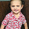 Layla joined the competition — help win amazing prizes! child, toddler, girl, smiling, portrait, pigtails, pajamas, heart_pattern, earrings, blue_eyes, indoors, wooden_background, seated, happy, face, person, closeup, casual_clothing, photography, adorable