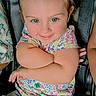 Layla is registered to the contest to win money with this photo: toddler, child, baby, smiling, happy, portrait, face, eyes, floral_clothing, dress, car_seat, seatbelt, sitting, indoor, vehicle, close_up, light_hair, blue_eyes, crossed_arms, photography
