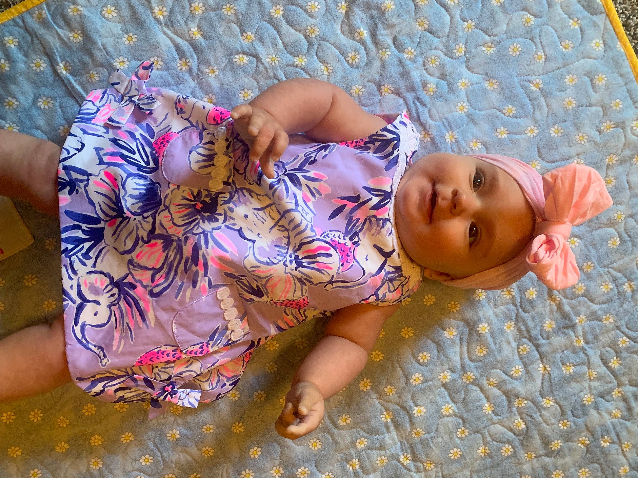 Harper joined the competition — help win amazing prizes! barefoot, chest, child, doll, flooring, foot, fun, grass, headwear, human_leg, joint, leg, leisure, linens, pattern, person, pink, sitting, skin, thigh