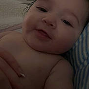 Elena joined the competition — help win amazing prizes! baby, infant, toddler, face, close_up, smile, wet_hair, blanket, towel, bed, hand, fingernails, pillow, skin, cozy, portrait, low_light, screenshot, status_bar, swipe_indicator