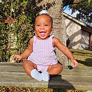 Aurora joined the competition — help win amazing prizes! baby, child, smiling, outdoor, bench, tree, grass, sunlight, happy, person, infant, nature, clothing, purple, playful, daylight, leaf, wood, socks, portrait