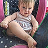 Willow is registered to the contest to win money with this photo: baby, infant, child, sitting, high_chair, polka_dots, pink, portrait, blue_eyes, blond_hair, smiling, indoors, tablet, foot, barefoot, clothing, romper, chair, warning_label, playful