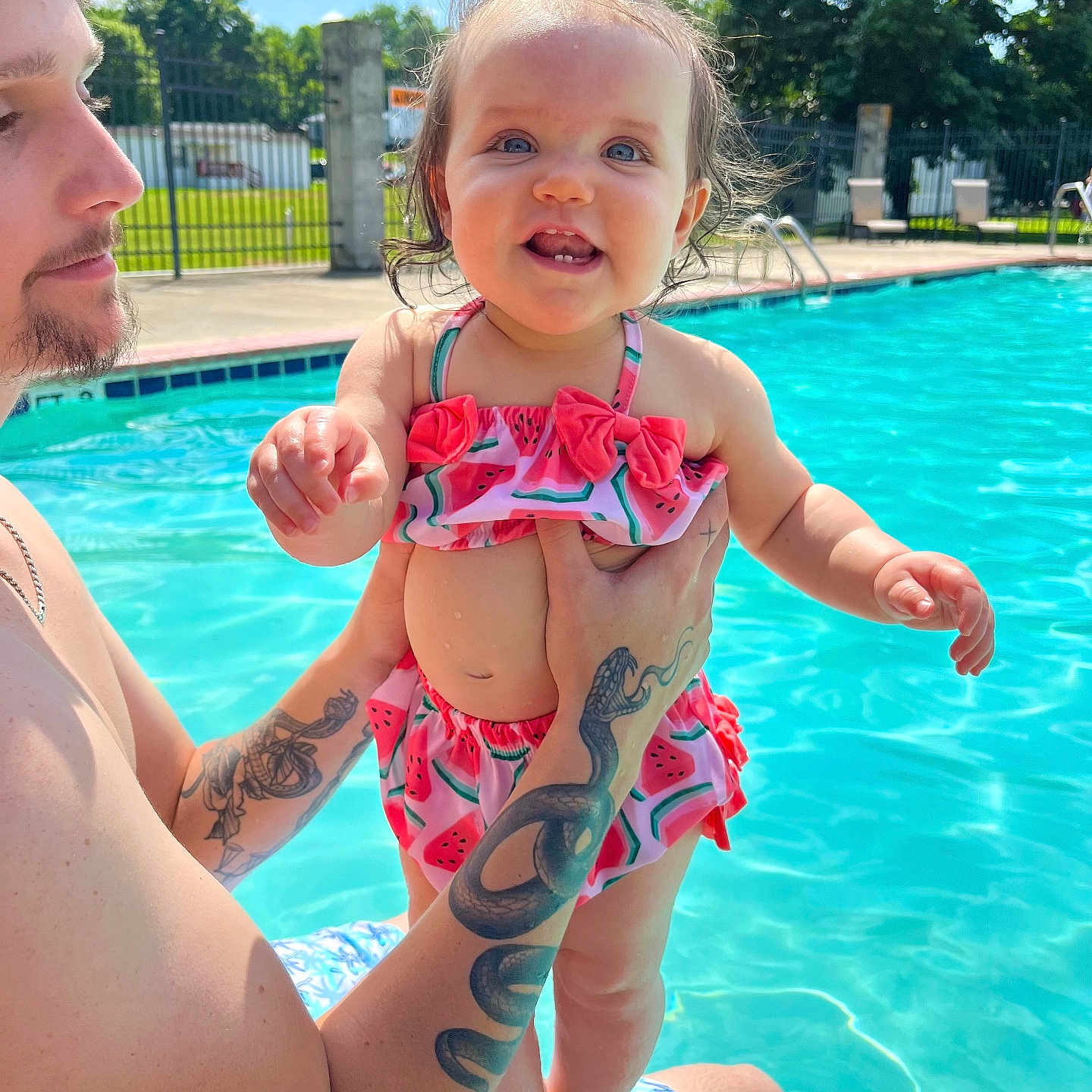 Avery is registered to the contest to win money with this photo: baby, chair, clothing, face, furniture, head, leisureactivities, person, photography, pool, portrait, skin, sport, summer, swimming, swimmingpool, swimwear, tattoo, water, watersports
