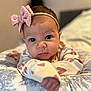 baby, infant, headband, bow, cushion, pattern, hand, face, eyes, clothing, cute, portrait, indoor, child, expression, resting, soft, young, person, focus