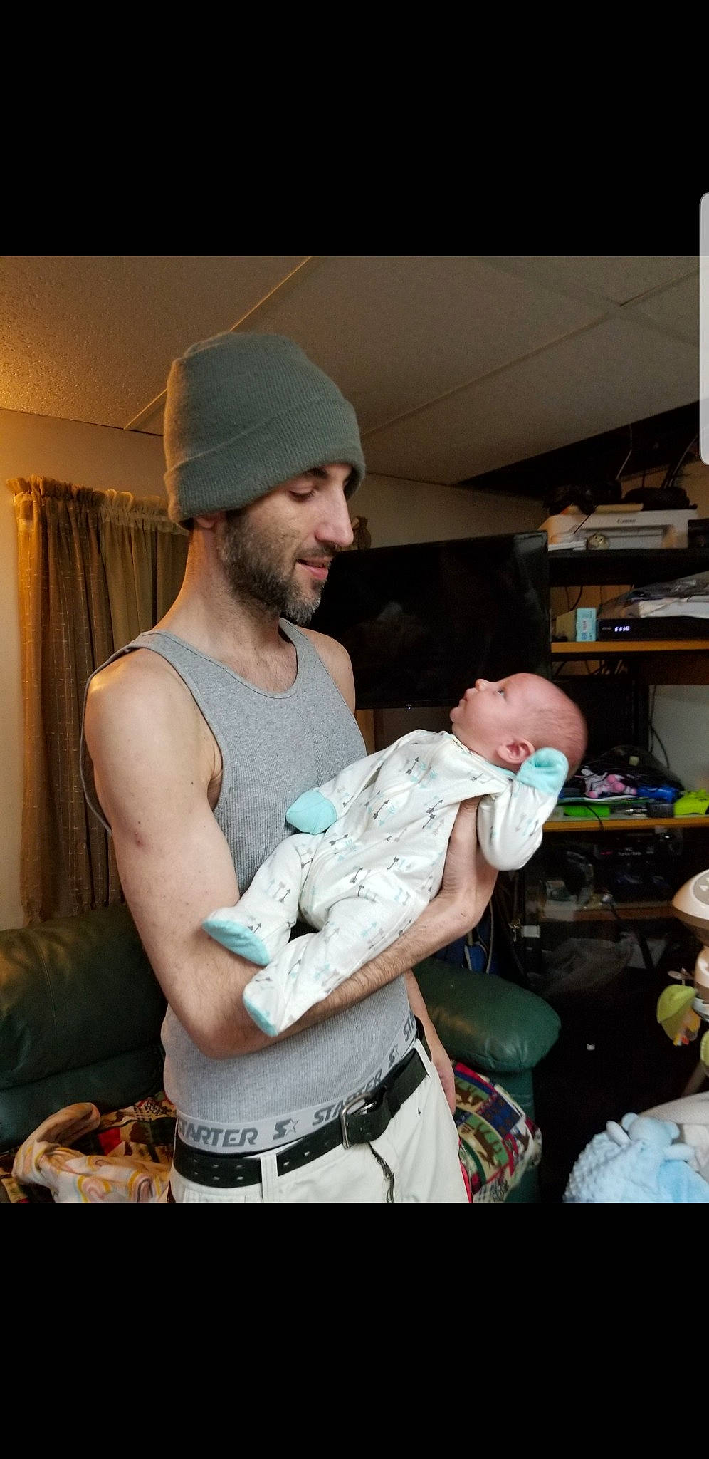 Austin joined the competition — help win amazing prizes! abdomen, baby, beard, belt, cap, cooking, curtain, event, facial_hair, fun, hairstyle, happy, headwear, human_body, muscle, person, shelf, sitting, smile, standing