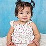 baby, child, infant, girl, pigtails, dress, cherry_pattern, fluffy_blanket, smile, cute, portrait, studio, blue_background, sitting, happy, innocence, young, skin, face, eyes