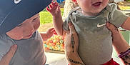 Paxton joined the competition — help win amazing prizes! baby, child, infant, toddler, smiling, hat, clothing, shorts, outdoor, daylight, tattoo, person, hand, playful, carnival, ferris_wheel, table, candy, happy, fun