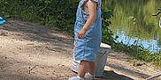 Hemmy participe au concours pour gagner de l'argent avec cette photo : toddler, child, denim_dress, outdoor, pond, tree, bucket, dirt_path, grass, fishing_rod, nature, summer, sunlight, person, young_child, curious, standing, water, leaves, daytime