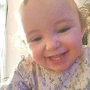 Hemmy participe au concours pour gagner de l'argent avec cette photo : toddler, child, smiling, face, curly_hair, indoor, window, wallpaper, clothing, patterned, happy, portrait, baby, person, cute, sitting, closeup, soft_light, young_child, joyful