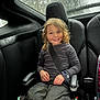 Arabella joined the competition — help win amazing prizes! child, car_seat, seatbelt, curly_hair, smiling, rain, window, car_interior, black_clothing, happy, young, seat, automobile, boy, casual_clothing, safety, daylight, portrait, indoors, child_safety