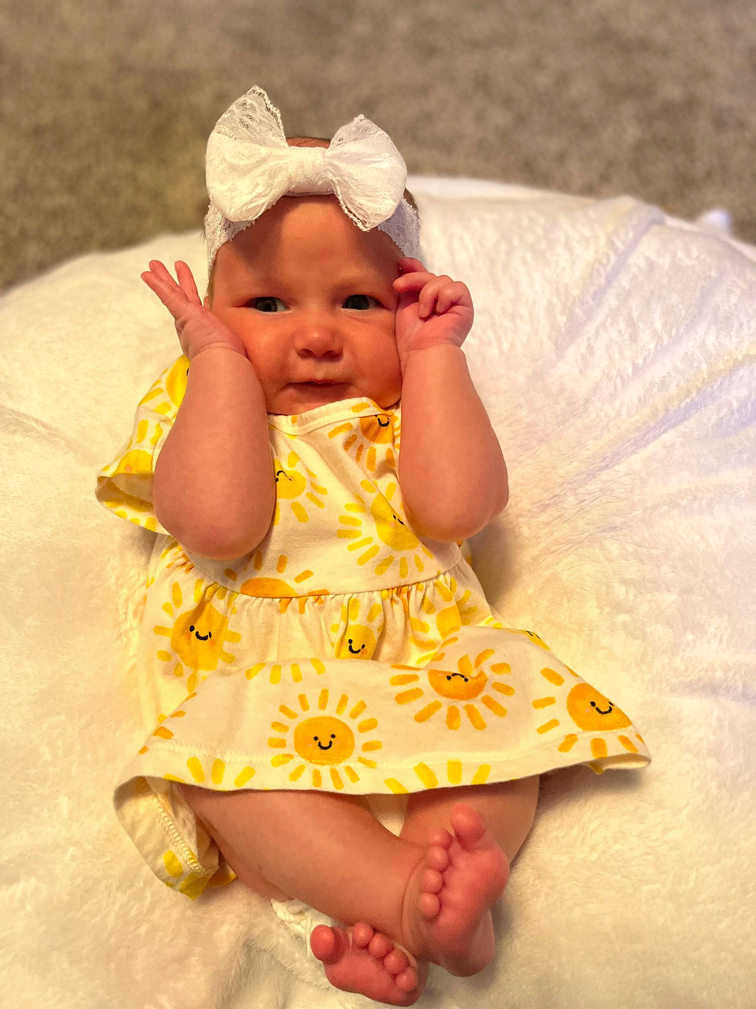 Lexi is registered to the contest to win money with this photo: baby, baby_toddler_clothing, cheek, child, dress, fashion_accessory, finger, fun, grass, happy, headwear, human_leg, lip, pattern, person, pink, sitting, skin, sleeve, sun_hat