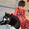 animal, black_cat, boy, casual, cat, child, couch, cozy, feline, friendship, happy, home, indoor, pet, playful, portrait, relaxing, smiling, spiderman_costume, white_paws