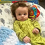 Nolan is registered to the contest to win money with this photo: baby, bed, bedroom, blanket, clothing, coat, couch, crib, cushion, face, furniture, head, homedecor, indoors, infantbed, person, photography, portrait, quilt, toy