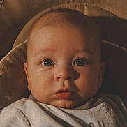 Raphaël participe au concours pour gagner de l'argent avec cette photo : baby, infant, face, eyes, onesie, clothing, portrait, closeup, child, cute, skin, head, expression, warm_lighting, newborn, young, person, indoors, soft_texture, babywear