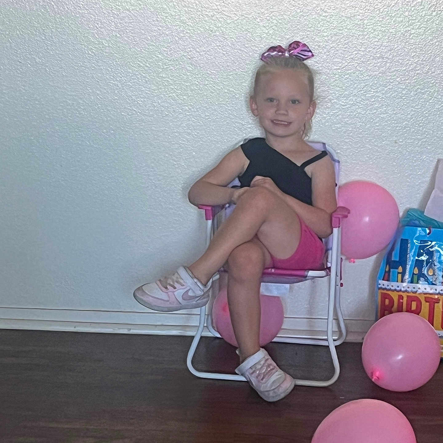 Kendra is registered to the contest to win money with this photo: ball, balloon, chair, child, clothing, face, female, football, footwear, furniture, girl, head, person, photography, portrait, purple, sandal, shoe, sitting, soccer