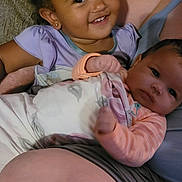 Serenity joined the competition — help win amazing prizes! children, toddler, baby, sibling, infant, smiling, happy, portrait, couch, indoors, family, cuddling, sitting, lying_down, purple_shirt, pink_clothing, curly_hair, dark_hair, baby_bottle, home