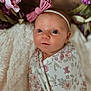 Wrenleigh is registered to the contest to win money with this photo: baby, infant, swaddled, blanket, headband, pink_bow, floral_pattern, soft_texture, closeup, portrait, cute, newborn, face, eyes, skin, indoors, decorative_flowers, wrapped, peaceful, child