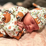 Wrenleigh is registered to the contest to win money with this photo: newborn, baby, sleeping, blanket, hat, floral_pattern, fox_pattern, soft_texture, pink, cozy, infant, cute, resting, peaceful, portrait, closeup, child, wrapped, clothing, indoors