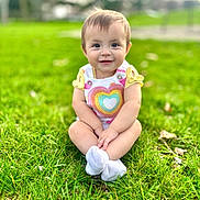 Melody is registered to the contest to win money with this photo: baby, child, clothing, cute, daytime, feet, grass, grass_field, greenery, happy, infant, nature, outdoor, person, playground, portrait, sitting, smiling, sunlight, young