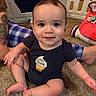 Theodore joined the competition — help win amazing prizes! baby, infant, child, onesie, smiling, tattoo, carpet, toy, playpen, indoor, person, footwear, blue, plaid, hand, face, cute, sitting, reaching, floor