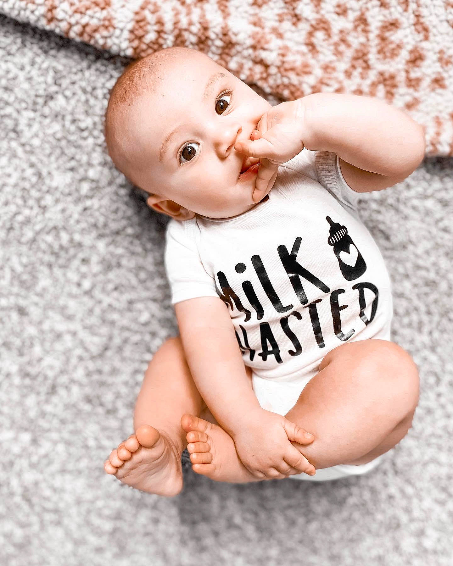 Calvin is registered to the contest to win money with this photo: baby, baby_toddler_clothing, cheek, child, chin, eye, finger, flash_photography, flooring, font, happy, joint, nail, pattern, person, pink, skin, sleeve, t_shirt, thumb