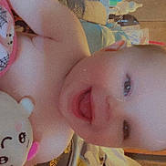 Amethyst Jade is registered to the contest to win money with this photo: baby, bed, blanket, child, couch, cute, expression, eyes, face, furniture, happy, head, indoors, infant, mouth_open, person, plush_toy, skin, smiling, soft_toy