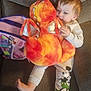 Kameron is registered to the contest to win money with this photo: toddler, child, plush_toy, stuffed_animal, dragon, couch, sofa, pajamas, mickey_mouse, foot, hand, toy_bag, fabric, indoor, relaxed, cute, soft_toy, child_playing, home, comfort