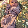 River joined the competition — help win amazing prizes! baby, infant, face, clothing, floral_pattern, cushion, animal_print, nature_print, cozy, portrait, indoors, soft_lighting, child, cute, relaxed, expression, person, newborn, pink, fabric