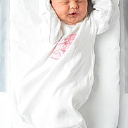River joined the competition — help win amazing prizes! newborn, baby, infant, sleeping, white_blanket, white_clothing, pink_embroidery, soft_bedding, peaceful, cute, portrait, indoors, child, face, head, skin, hands, lying_down, resting, cozy