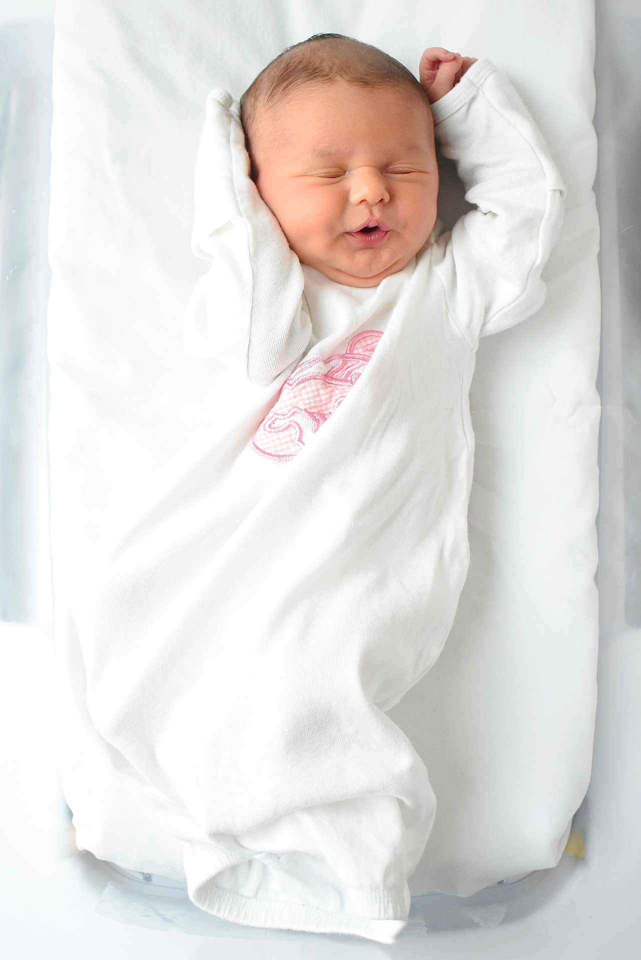 River joined the competition — help win amazing prizes! newborn, baby, infant, sleeping, white_blanket, white_clothing, pink_embroidery, soft_bedding, peaceful, cute, portrait, indoors, child, face, head, skin, hands, lying_down, resting, cozy