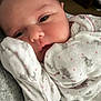 River is registered to the contest to win money with this photo: baby, infant, close_up, pajamas, elephant_pattern, sleepy, face, skin, cute, newborn, soft, clothing, child, portrait, indoors, warm, resting, tiny_hand, cozy, pink