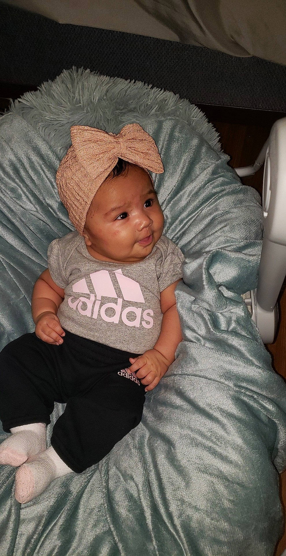 Maria is registered to the contest to win money with this photo: baby, baby_toddler_clothing, cap, cheek, child, comfort, eye, face, facial_expression, finger, head, headwear, human_body, iris, lap, mammal, person, sitting, skin, sleeve