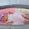 baby, bassinet, blanket, child, clothing, cozy, cute, gray, headband, indoors, infant, newborn, person, pink, portrait, purple, resting, sleeping_area, soft, tutu