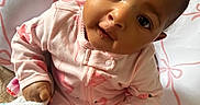 Emori joined the competition — help win amazing prizes! baby, infant, child, pink_pajamas, flamingo_pattern, blanket, cushion, seated, curious_expression, indoors, face, hand, footwear, cute, person, portrait, sleepwear, soft_toys, home, comfort