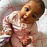 baby, blanket, child, comfort, curious_expression, cushion, cute, face, flamingo_pattern, footwear, hand, home, indoors, infant, person, pink_pajamas, portrait, seated, sleepwear, soft_toys