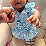 Emori joined the competition — help win amazing prizes! baby, child, hand, holding, blue_dress, sandals, smiling, face, chair, cushion, person, indoor, skin, happy, clothing, footwear, hand_sanitizer, close_up, cute, infant