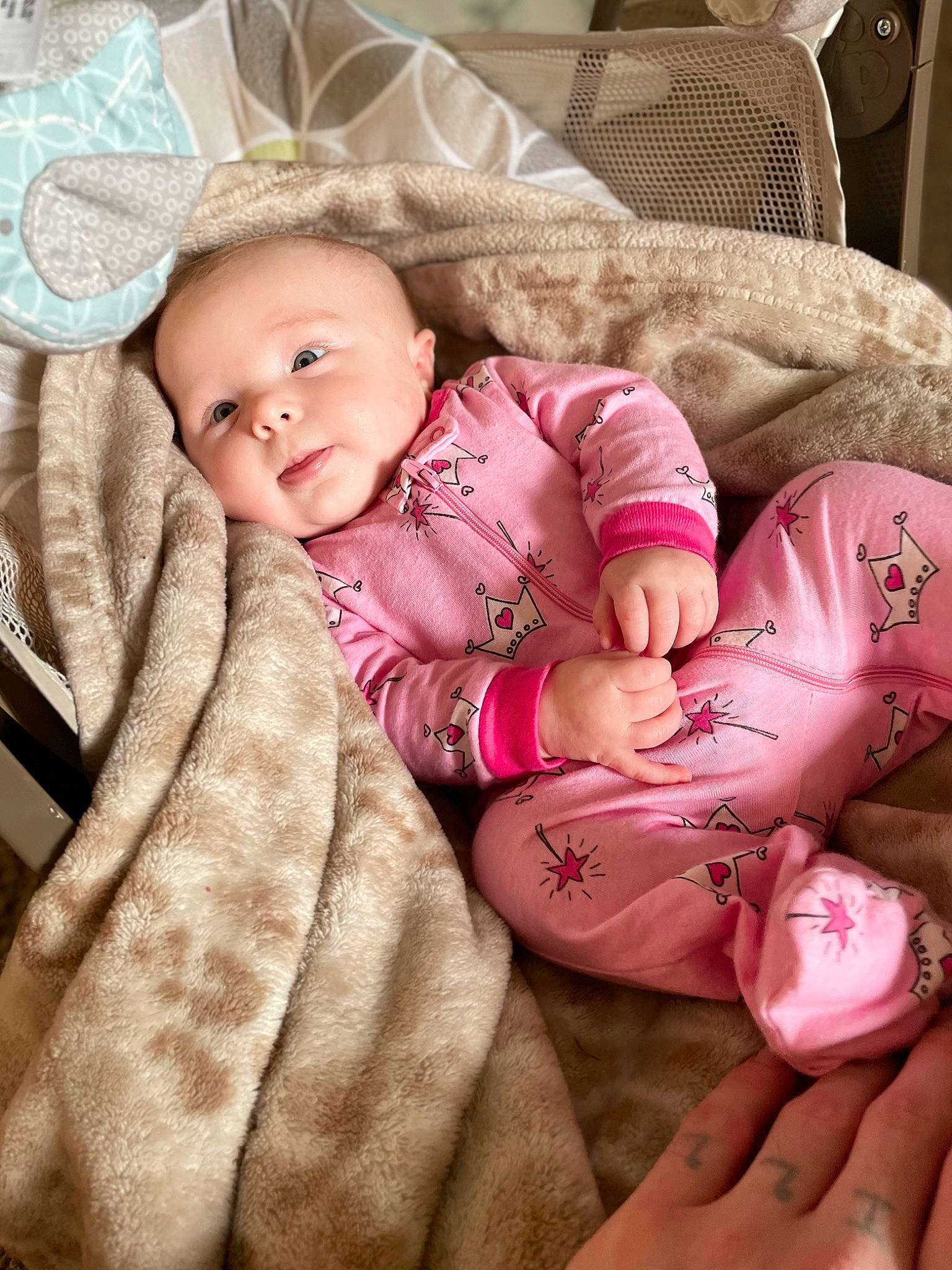 Harlow is registered to the contest to win money with this photo: baby, baby_products, baby_toddler_clothing, cheek, child, comfort, eye, finger, gesture, iris, linens, lip, nail, person, pink, skin, sleeve, smile, textile, thumb
