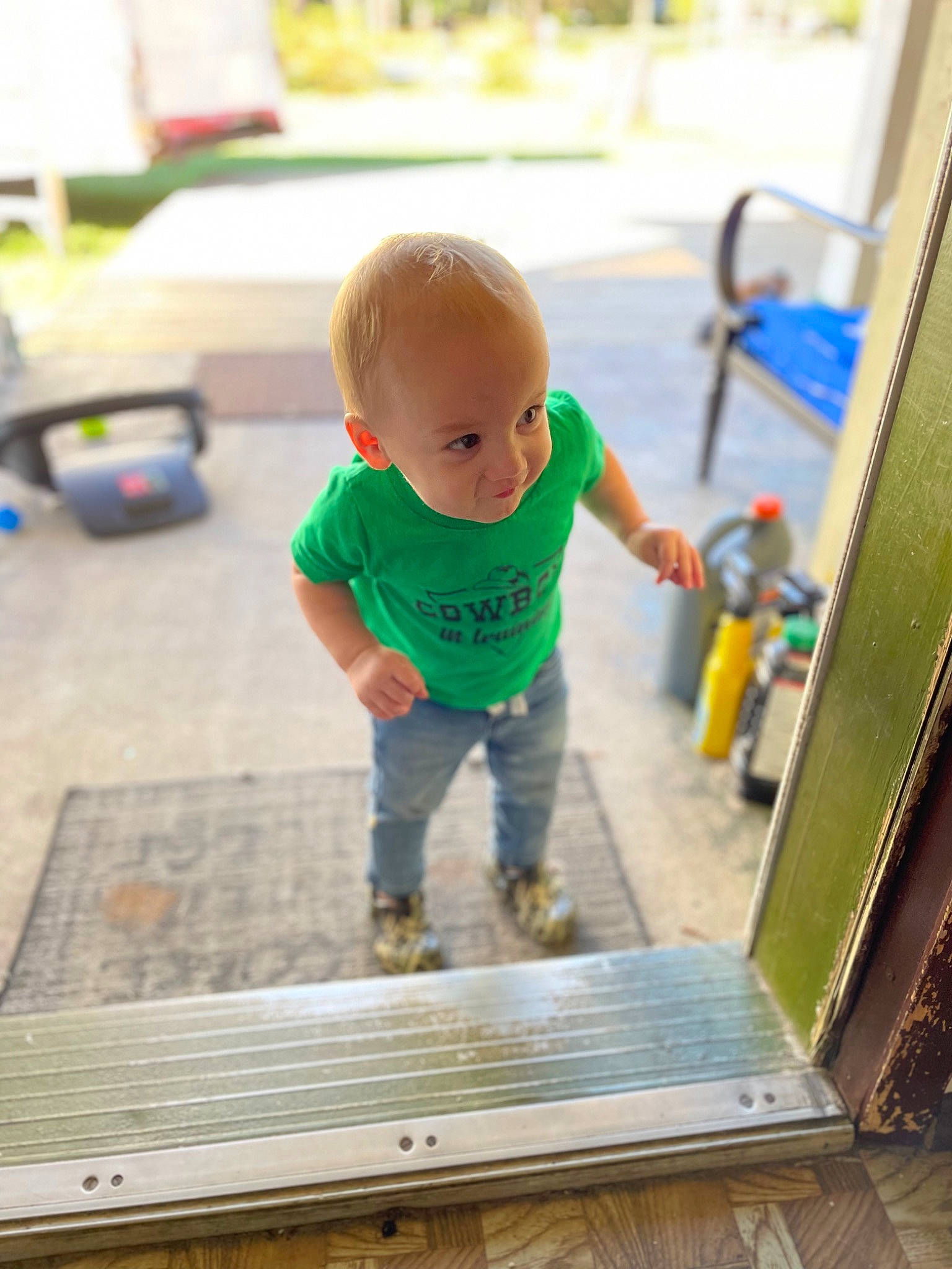 Greyson is registered to the contest to win money with this photo: baby, baby_products, baby_toddler_clothing, child, floor, flooring, fun, grass, hardwood, leisure, person, play, room, sitting, standing, t_shirt, table, toddler, wood, wood_flooring