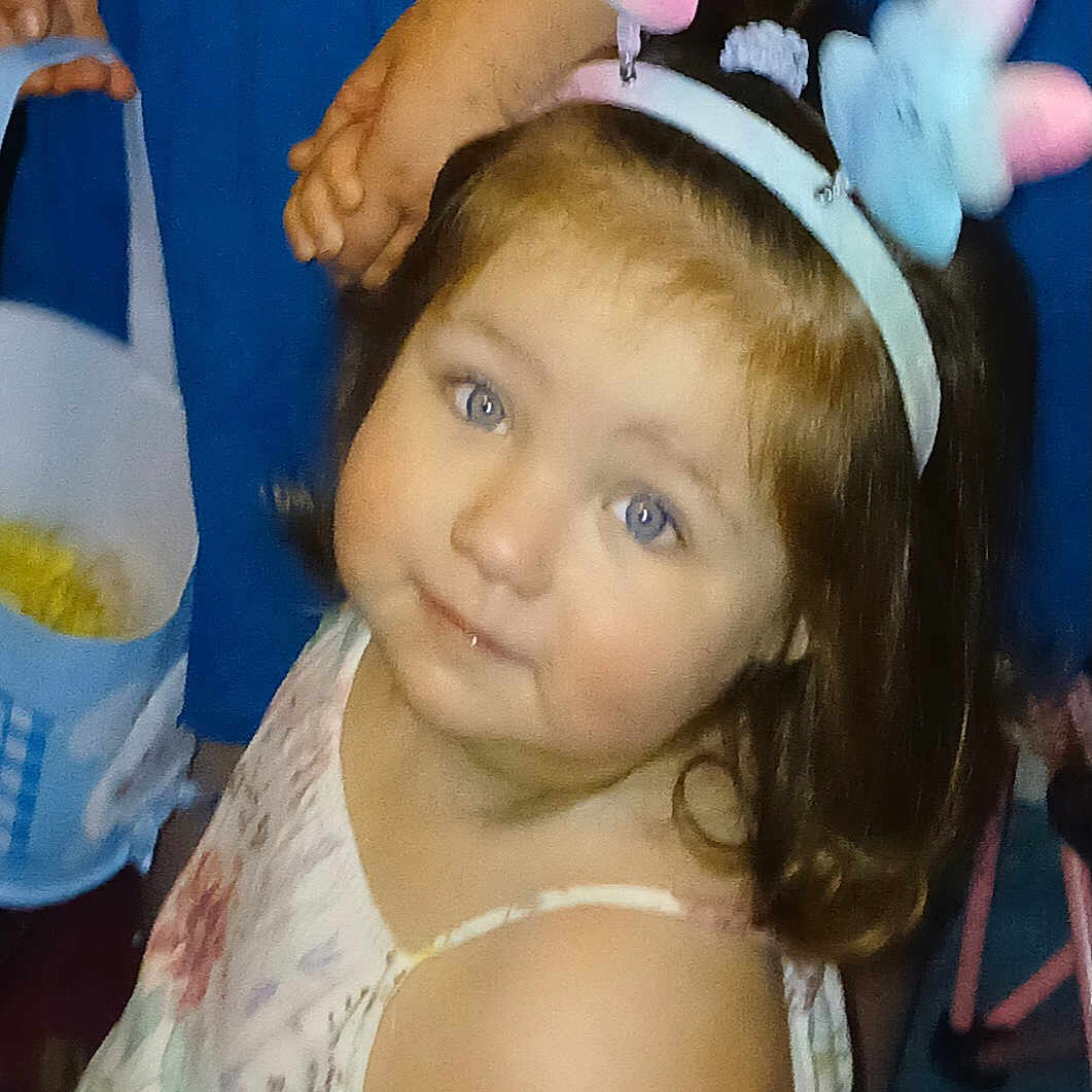 Phoenix Massey is registered to the contest to win money with this photo: blue_background, butterfly, child, curious, cute, face, floral_dress, girl, hair, hand, headband, holding_hands, indoors, innocence, person, portrait, smile, soft_focus, toddler, young_child