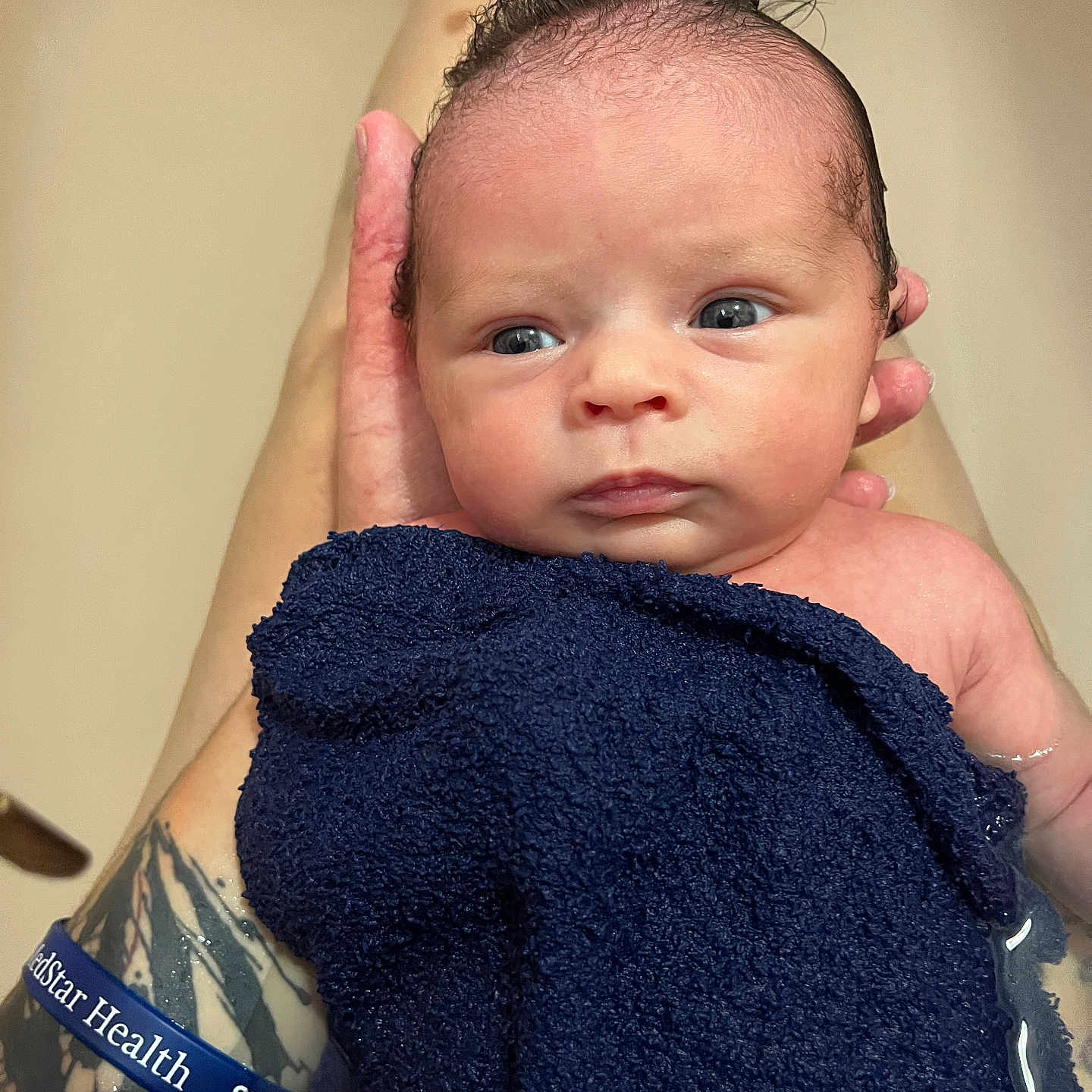 Julianna joined the competition — help win amazing prizes! baby, baby_care, bath, blue, closeup, cute, expression, face, hand, human, infant, newborn, newborn_bath, person, portrait, skin, tattoo, towel, water, wet
