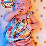Amiyah joined the competition — help win amazing prizes! baby, infant, child, pink_bow, colorful_clothing, hand_in_mouth, milestone, floral_frame, text_overlay, lying_down, polka_dot_blanket, cute, smiling, portrait, closeup, headband, happy, skin, cheeks, baby_girl