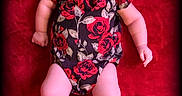 Amiyah is registered to the contest to win money with this photo: baby, infant, smiling, red_blanket, headband, floral_outfit, pink_shoes, portrait, milestone_badge, cute, lying_down, chubby_arms, chubby_legs, indoors, happy, child, face, person, closeup, soft_lighting